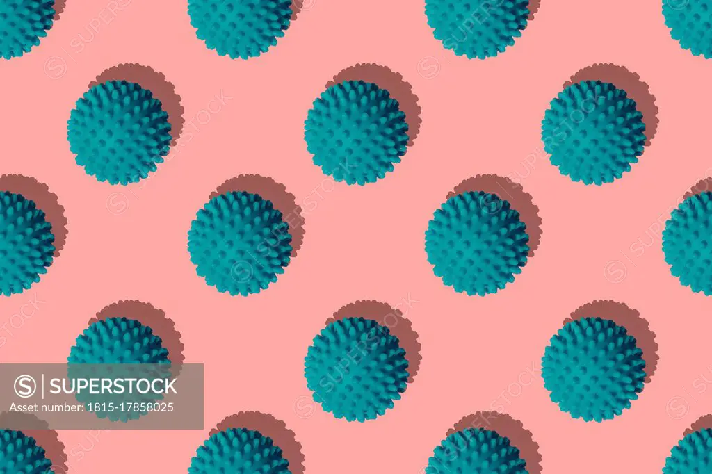 Teal balls arranged on coral background