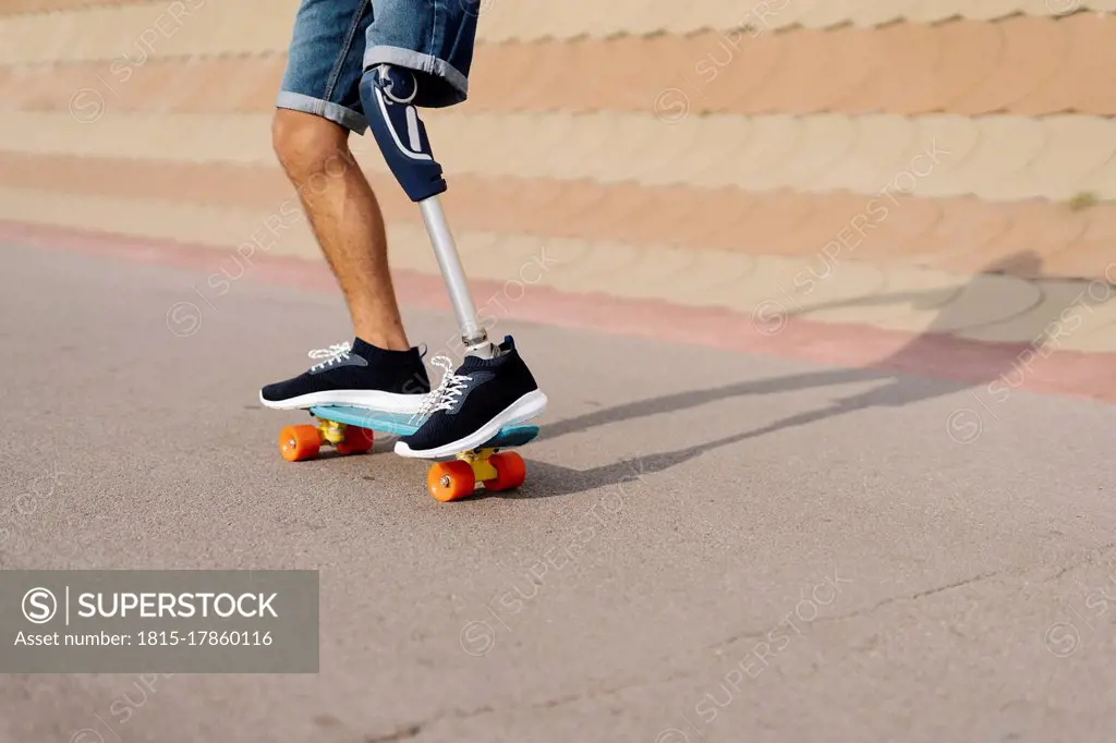 Disabled athlete skateboarding at sports court