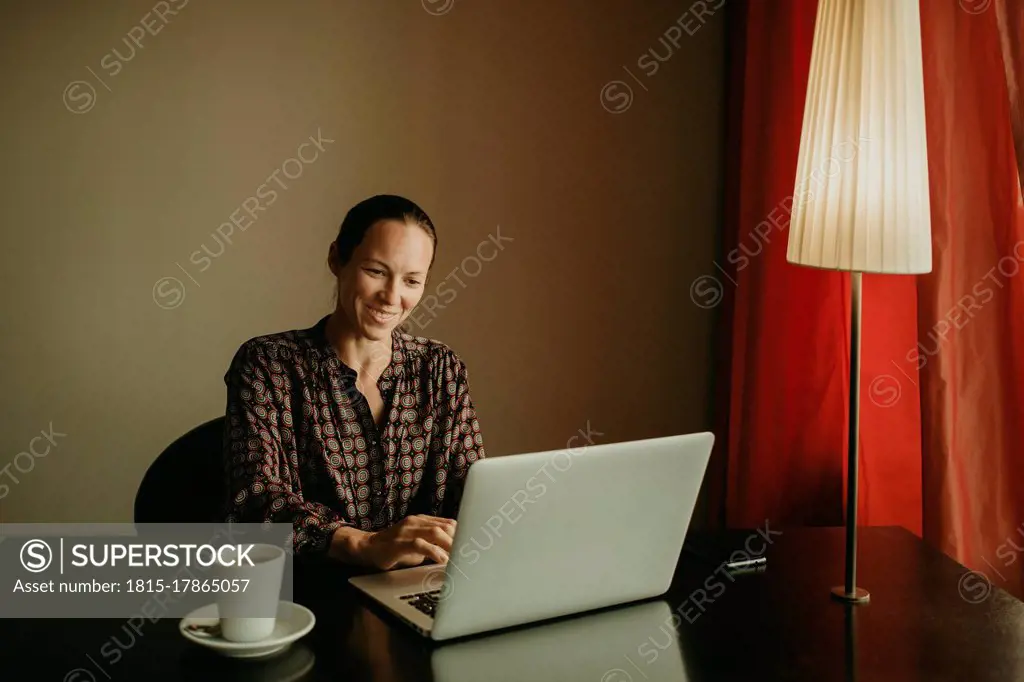 Female entrepreneur smiling while working in office