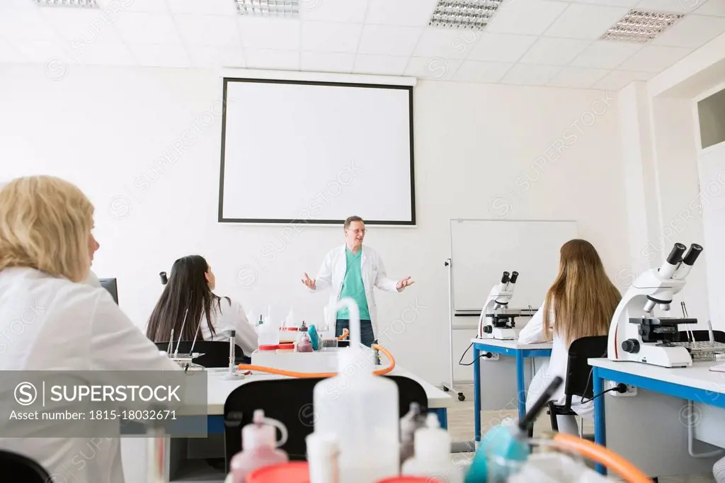 Students and teacher working in science class