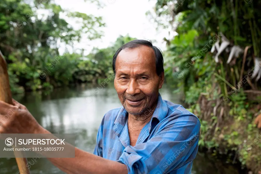 Smiling senior Guarani man at Napo River, Ecuador