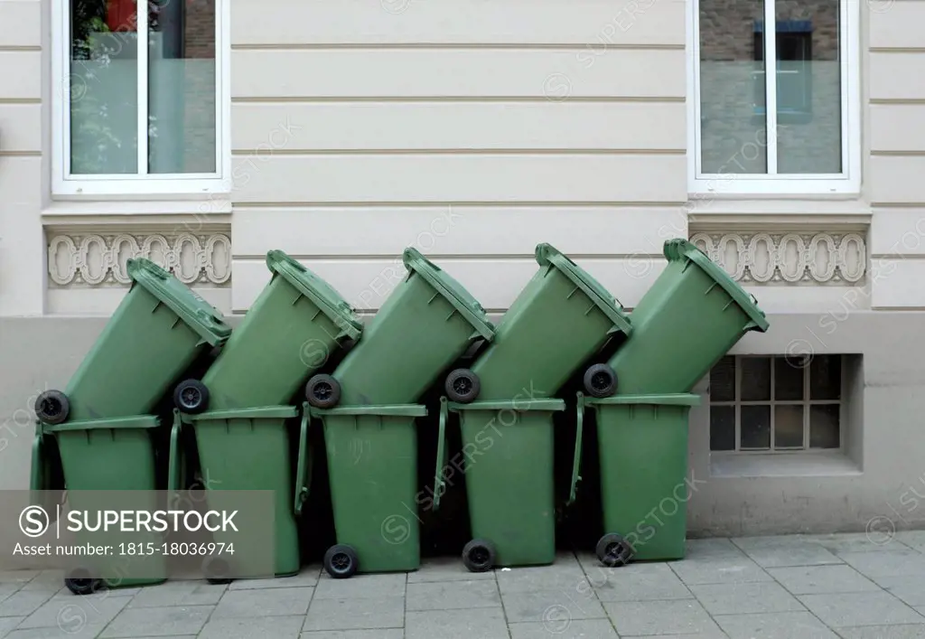 Germany, Hamburg, Altona, Garbage cans piled up in residential area