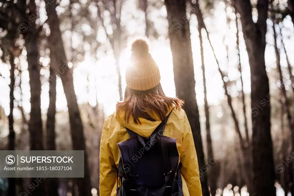 Woman with backpack exploring in forest