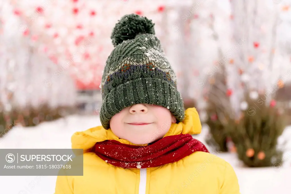 Boy hiding his face with knit hat