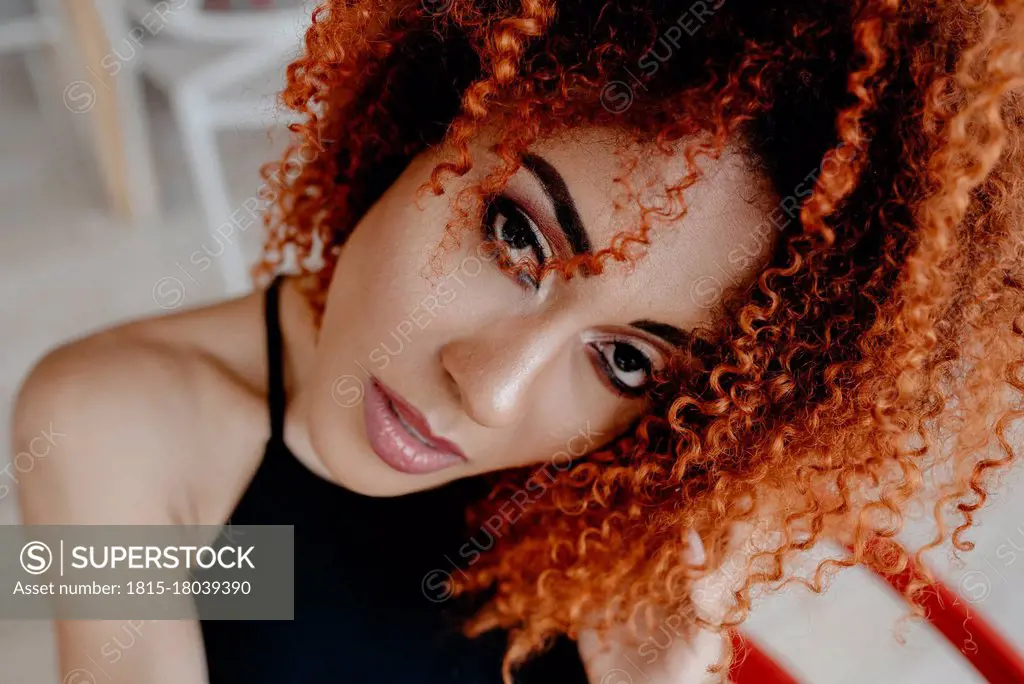 Confident woman Afro brown hair at cafe