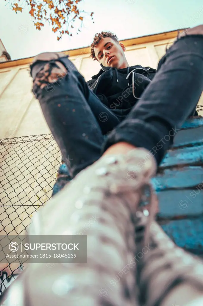 Man sitting on graffiti wall