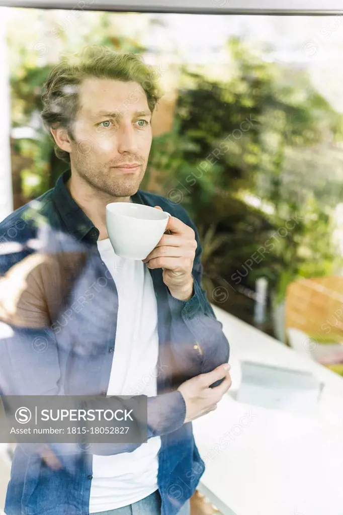 Focused Man Drinking From Cup Stock Photo - Download Image Now - Men,  Coffee - Drink, Window - iStock
