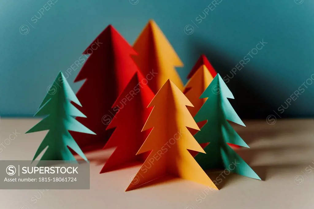 Studio shot of simple paper craft forest trees in autumn colors