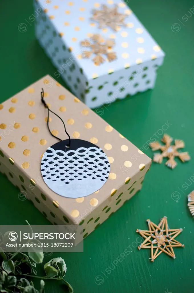 Wrapped Christmas present and name tag made of doily