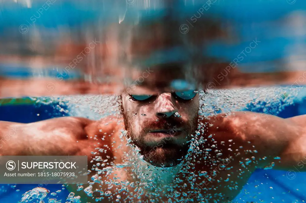 Close-up of swimmer diving underwater in swimming pool