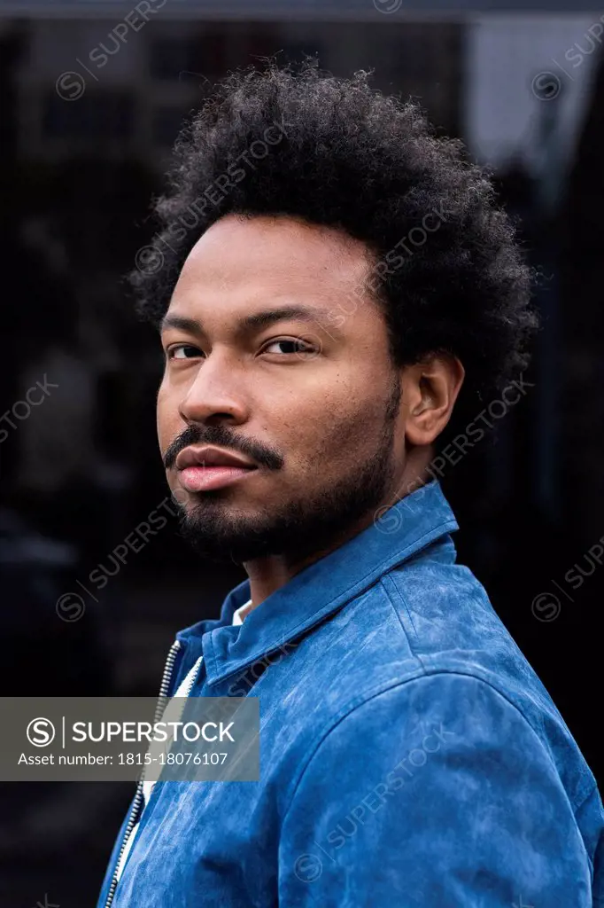 Close-up portrait of serious stylish man with afro hair