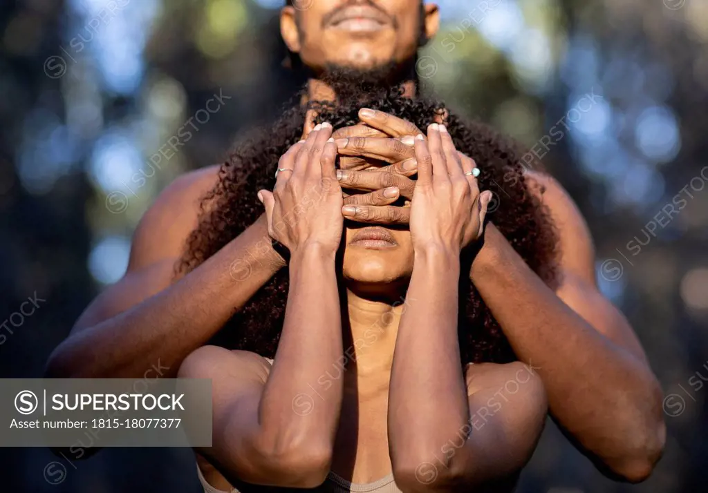 Male dancer covering eyes of female partner during performance