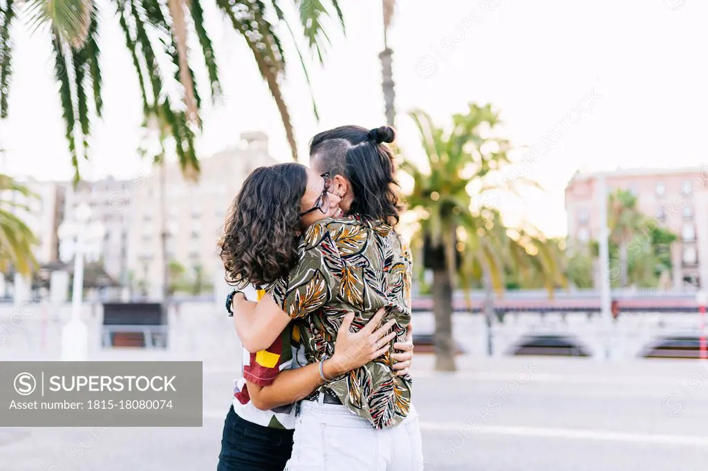 Young lesbian couple embracing each other on street in city