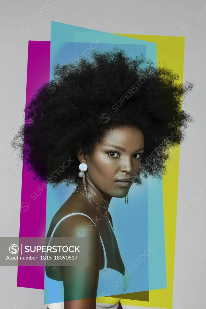 Attractive Afro woman with primary colors against white background