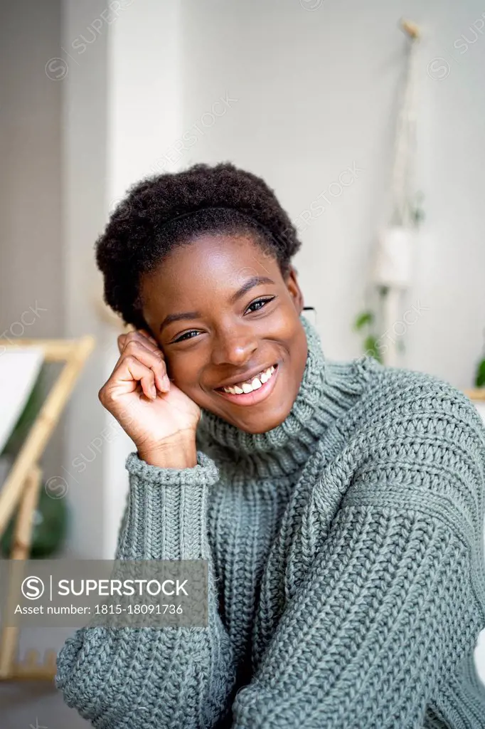 Smiling woman wearing turtleneck at home