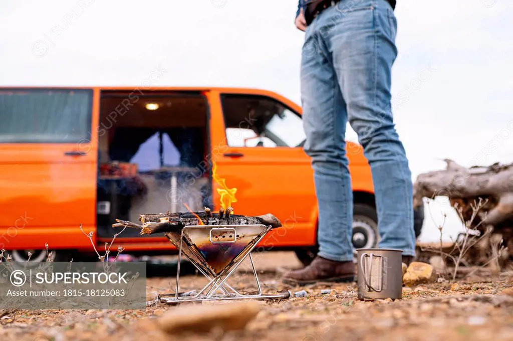 Man standing in front of camping stove