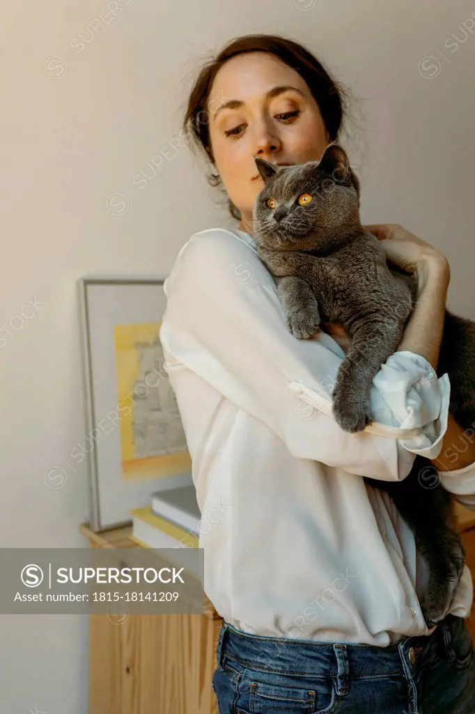 Woman holding Chartreux cat at home