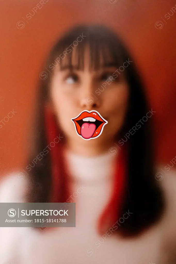 Lips on plastic sheet in front of woman