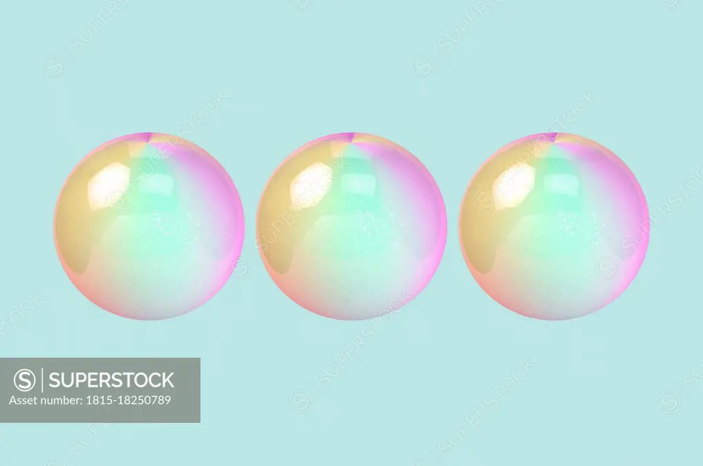 Three dimensional render of three bubbles against green background