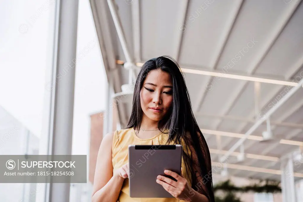 Female professional using digital tablet at office