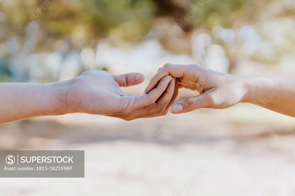 Boyfriend holding hand of girlfriend