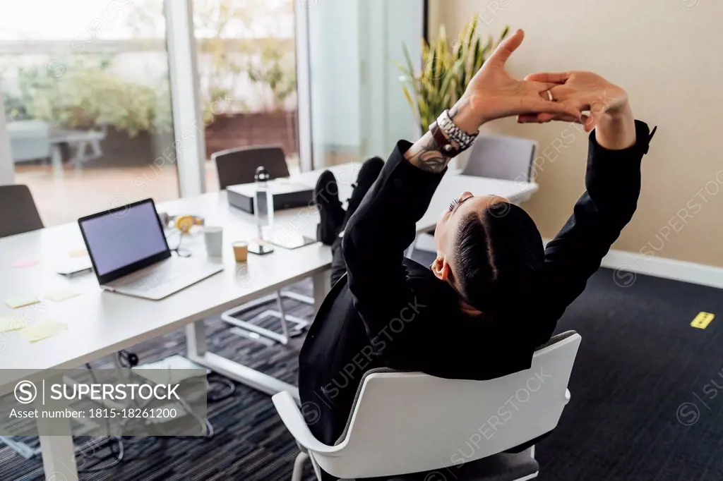 Young professional resting on chair in office