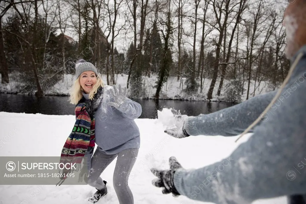 Senior couple playing with snow during winter