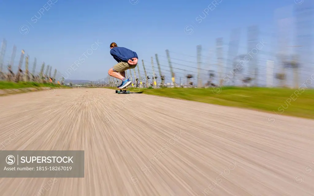 Young man skating on road