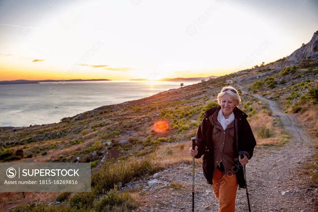 Smiling senior woman hiking near Adriatic sea in Omis, Dalmatia, Croatia