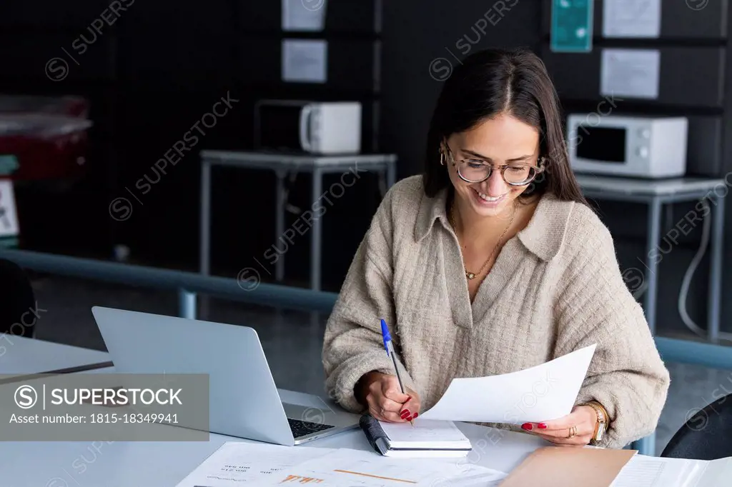 Smiling businesswoman working at office