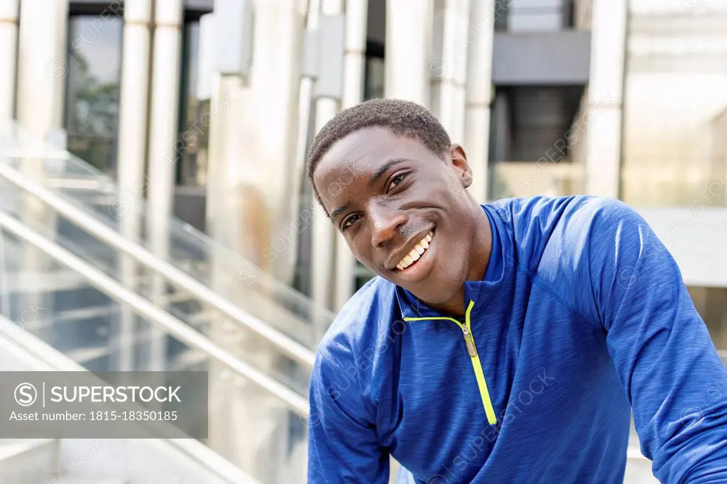 Smiling man standing on staircase