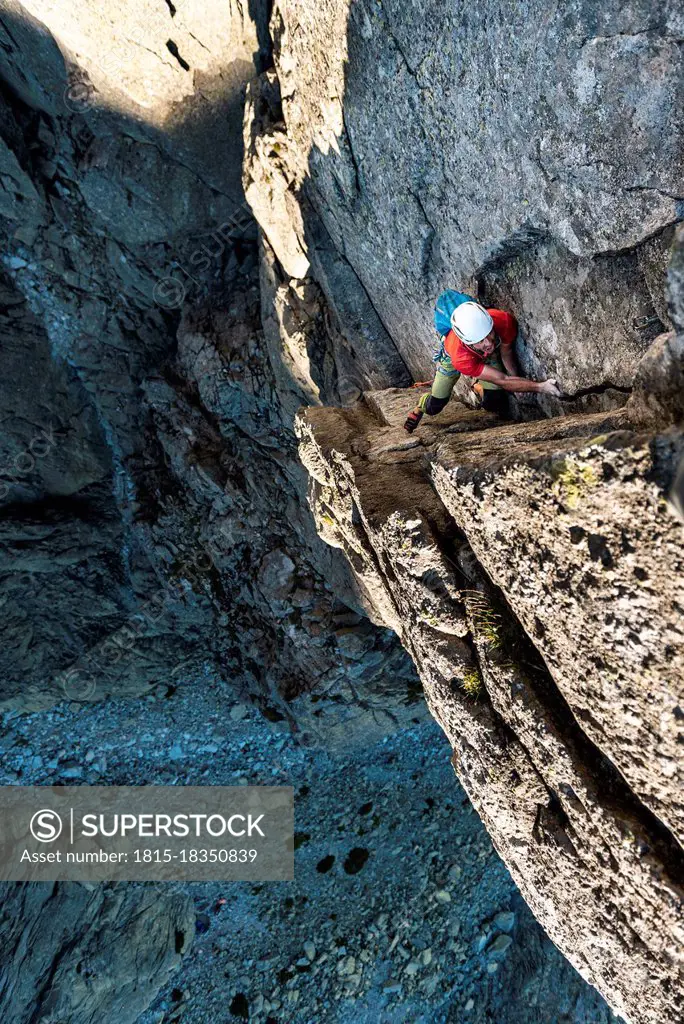Caucasian man climbing rock mountains