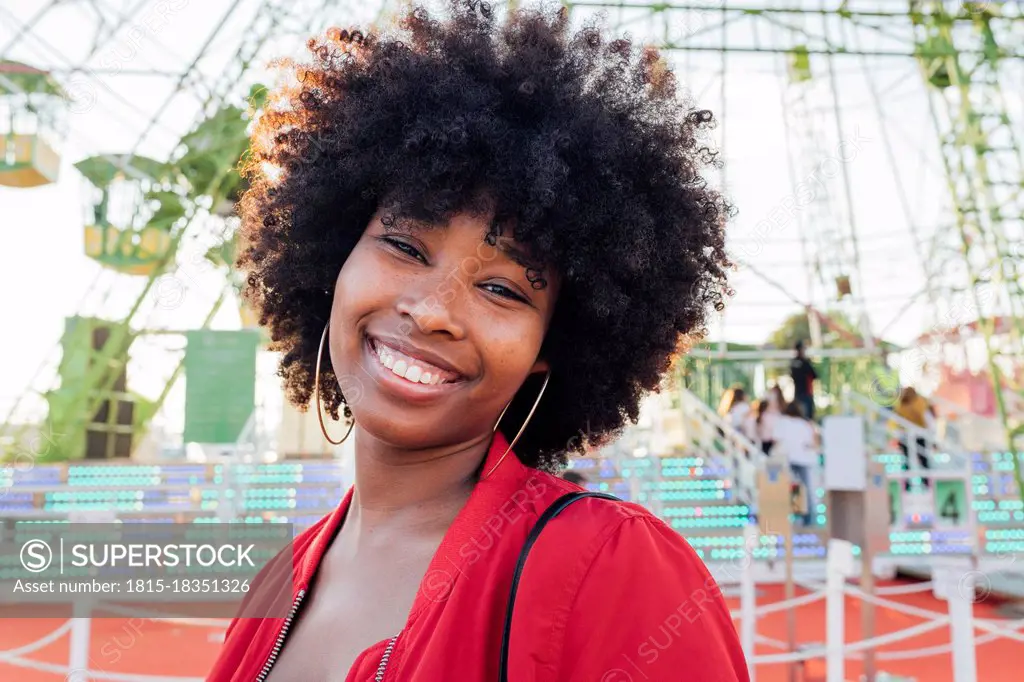 Young woman smiling in amusement park