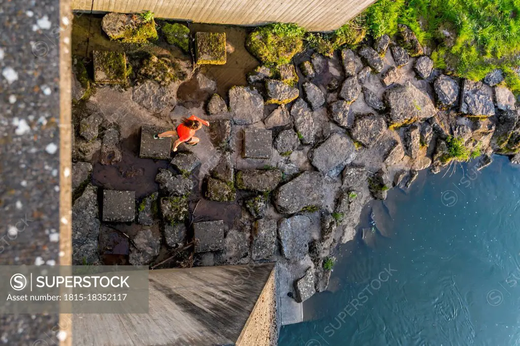 Germany, Baden Wurttemberg, Lorch, Directly above view of young woman jogging near lock on Rems river