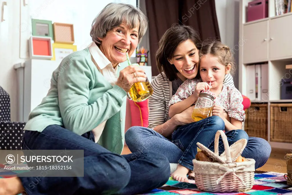 Multi-generation family playing picnic in nursery