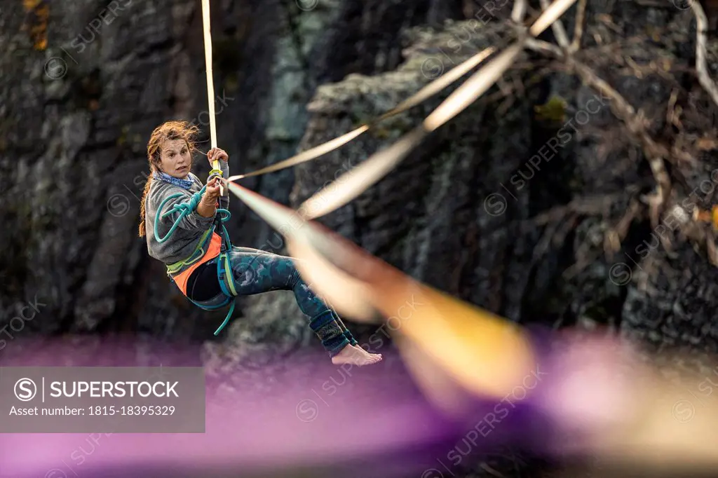 Young woman highlining in mountains at Baden-Baden, Germany