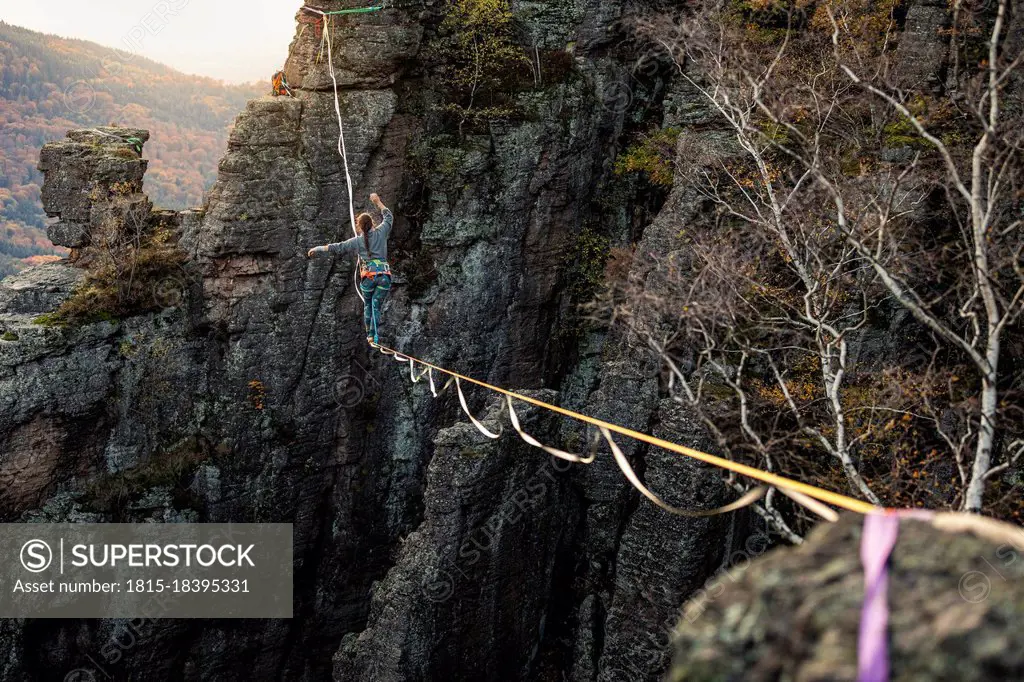 Woman balancing while highlining at Baden-Baden, Germany