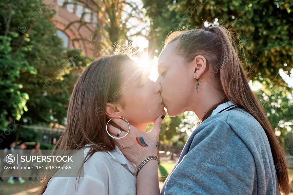 Young couple kissing on mouth at park