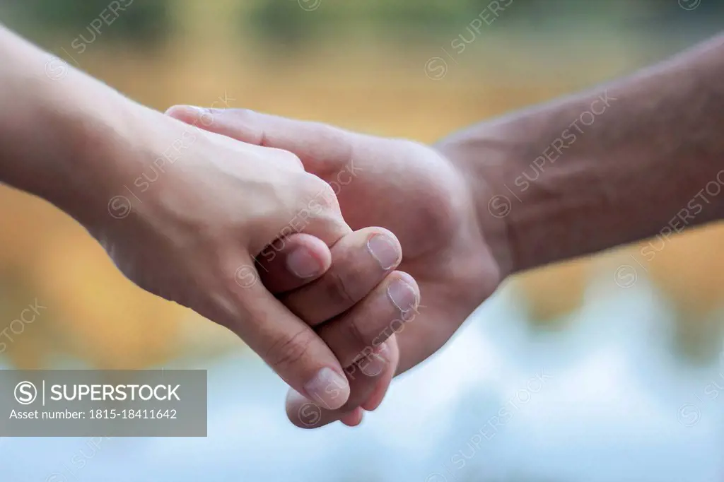 Young multi-ethnic couple holding hands