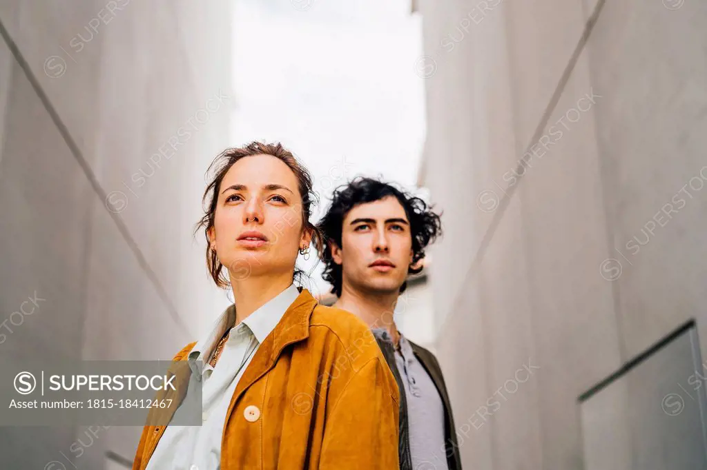 Couple wearing jackets looking away