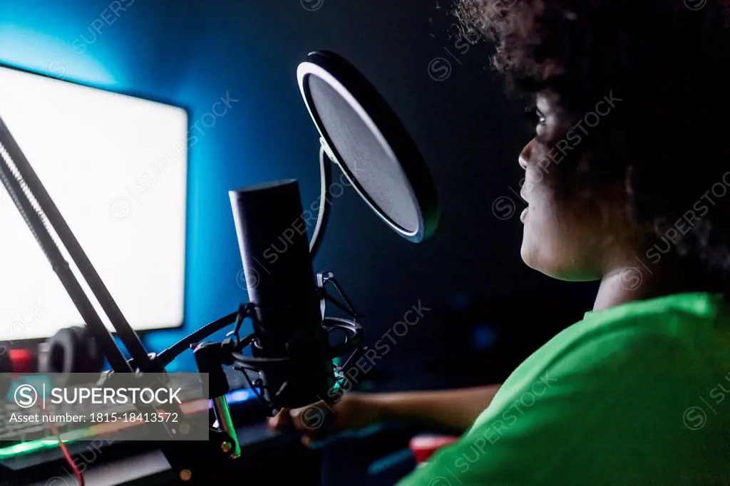 Boy doing online streaming while playing video game at home