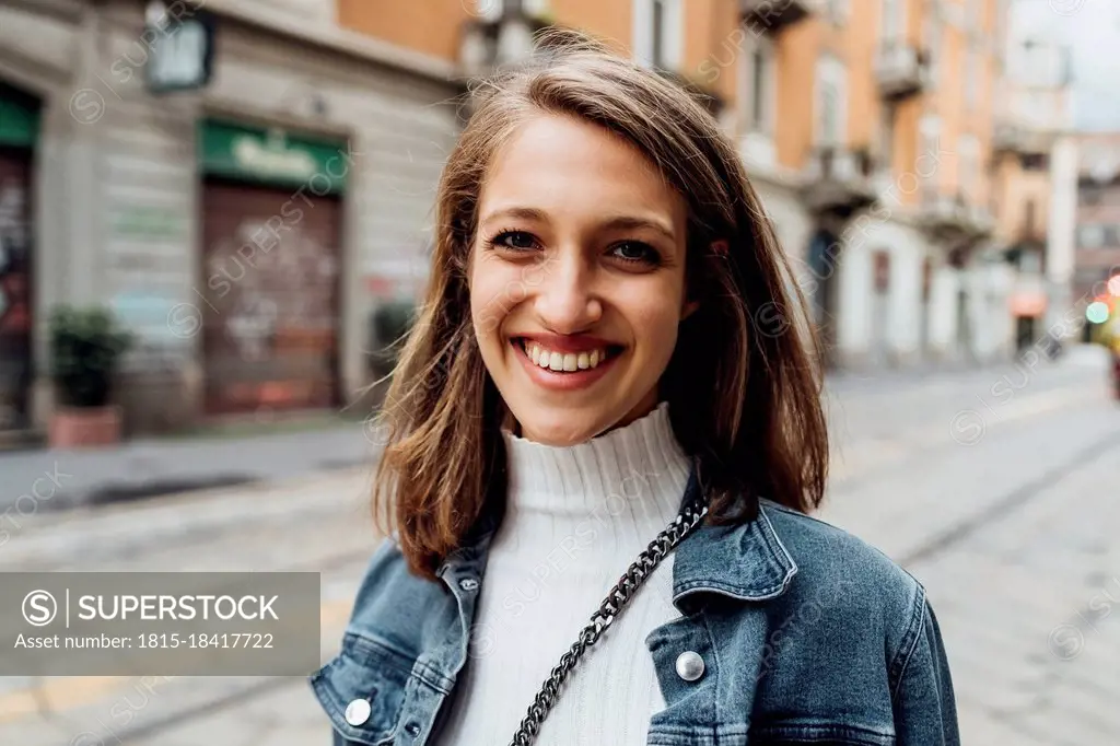 Young woman smiling while staring