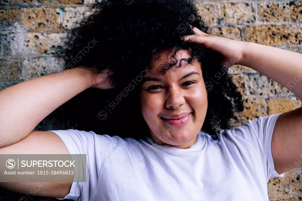 Young woman with hands in hair