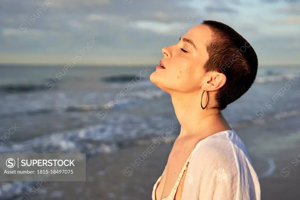 Woman with eyes closed at beach