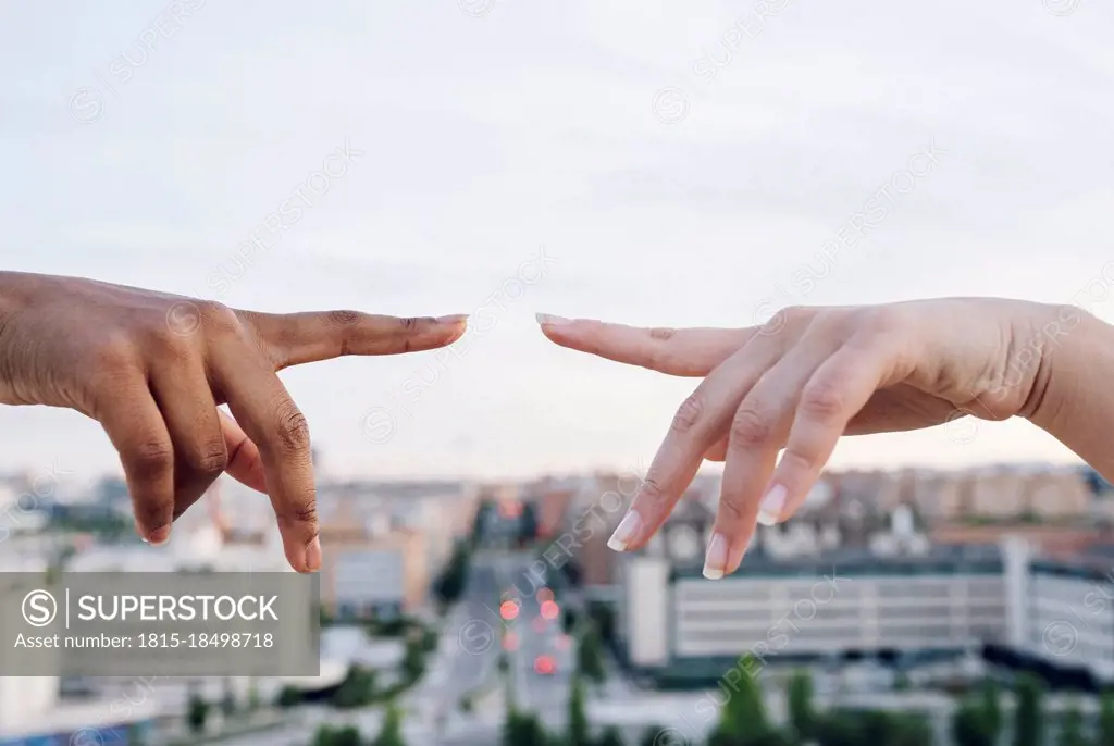 Lesbian couple pointing at each other