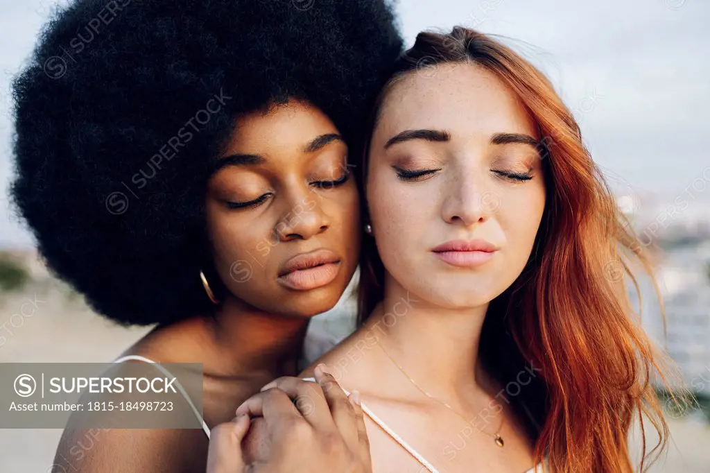 Young lesbian couple with eyes closed