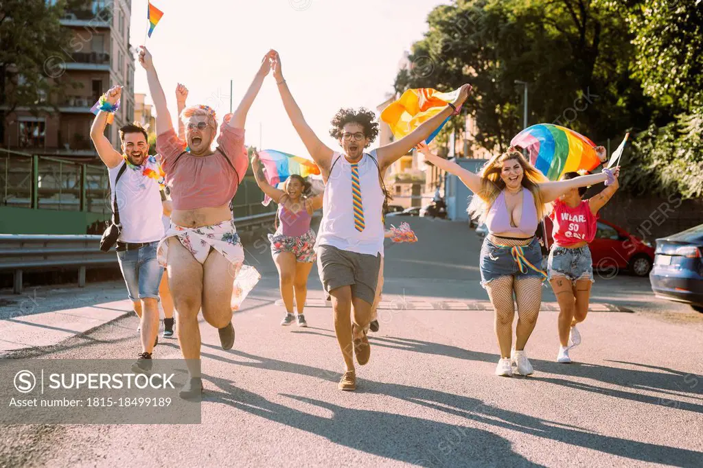 Multi-ethnic male and female protesters running on street