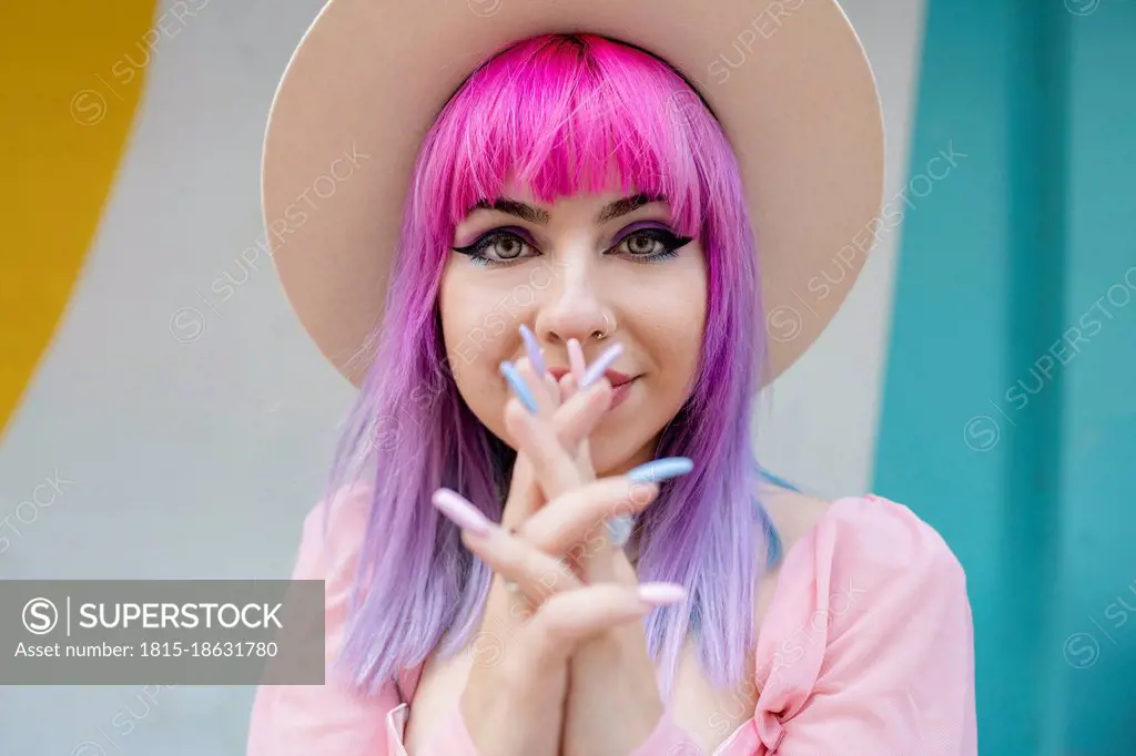 Fashionable woman with hands clasped