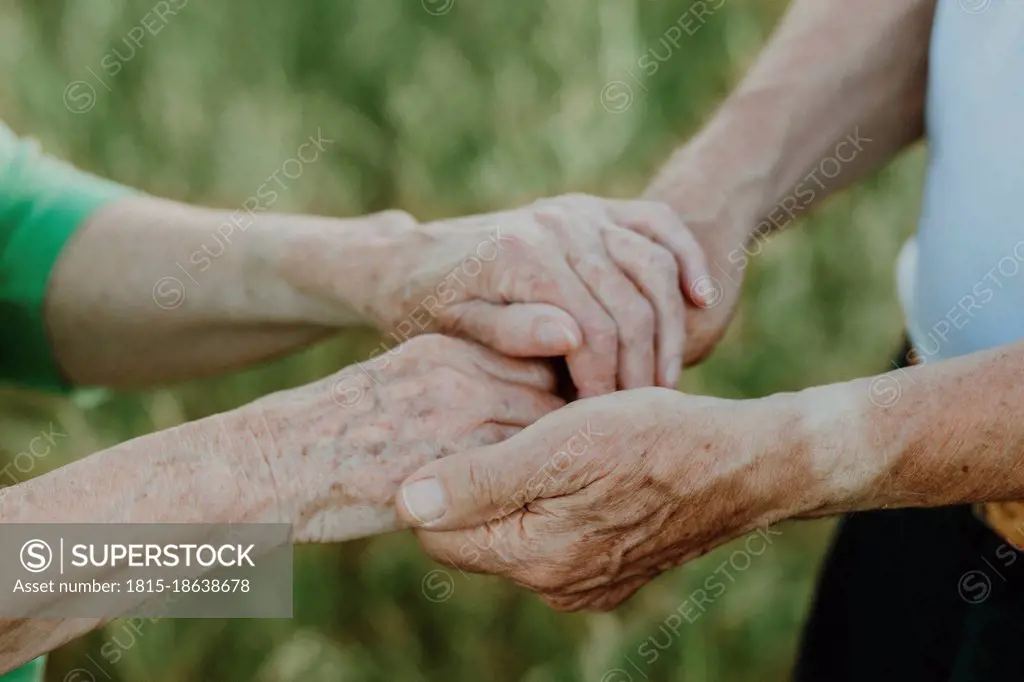 Senior couple holding hands