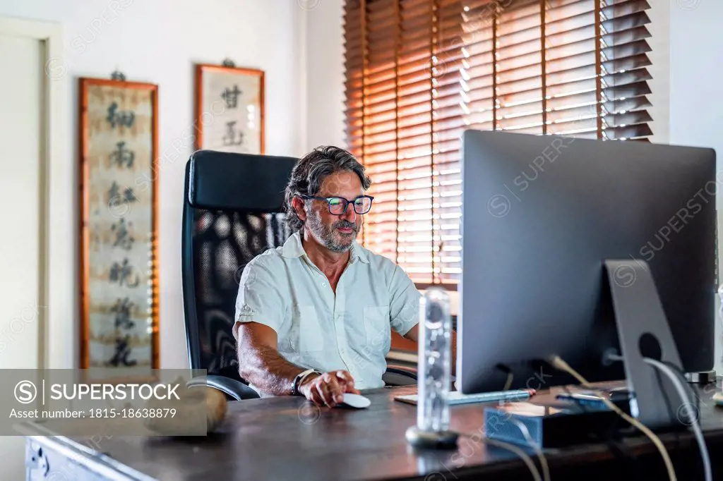 Businessman using computer while sitting at home office